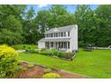 Beautiful home exterior with a manicured lawn, trampoline, and lovely landscaping at 3421 Kistler Ct, Willow Springs, NC 27592