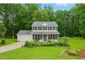 Inviting two-story home with a well-manicured front yard, pool and a classic American facade at 3421 Kistler Ct, Willow Springs, NC 27592