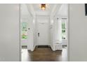 Bright foyer with wood floors leading to a naturally lit home through the front door at 3421 Kistler Ct, Willow Springs, NC 27592