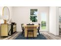 Light filled dining room features a wood table, black chairs, and a stylish sideboard at 4014 Silver Oak Ln, Durham, NC 27703