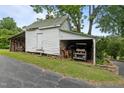 Rustic shed with a carport, providing ample storage space and shelter for a golf cart at 4053 Friendship Patterson Mill Road, Burlington, NC 27215