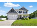 Beautiful two-story home with a well-maintained lawn and a spacious two-car garage at 414 Fallingbrook Dr, Kenly, NC 27542