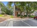 Attractive townhome showcasing a brick and siding exterior, enhanced by mature trees and manicured greenery at 4406 Still Pines Dr, Raleigh, NC 27613