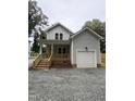 Charming two-story home featuring a welcoming front porch and a convenient attached garage at 4511 Denfield St, Durham, NC 27704
