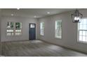 Bright and airy living room with stylish floors, neutral walls and lots of natural light at 4511 Denfield St, Durham, NC 27704