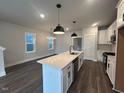 Bright open kitchen featuring a large center island and stainless steel appliances at 502 Yeowell Dr, Chapel Hill, NC 27514