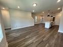 Open-concept living room with hardwood floors flowing into the kitchen at 502 Yeowell Dr, Chapel Hill, NC 27514