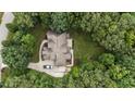 Aerial view of the house surrounded by mature trees, including driveway and surrounding landscaping at 512 Belmont Cir, Wake Forest, NC 27587
