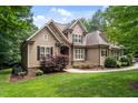 A charming two-story home with stone accents and professionally landscaped yard at 512 Belmont Cir, Wake Forest, NC 27587
