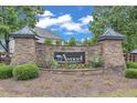 Stone entrance sign for Avocet featuring lush landscaping and manicured plants at 7008 Rex, Holly Springs, NC 27540