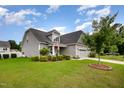 Beautiful home exterior displaying lush landscaping, a manicured lawn, and a well-maintained facade at 71 Sanibel St, Clayton, NC 27520
