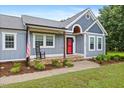 Charming home with a covered porch, lush landscaping, and a welcoming entrance, radiating curb appeal at 7132 Deer Brook St, Willow Springs, NC 27592