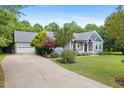 Charming home with a well-manicured lawn, inviting front porch, and an attached garage for convenience at 7132 Deer Brook St, Willow Springs, NC 27592