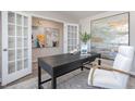 Comfortable home office with french doors, modern desk, and stylish decor at 7456 Michelle Rd, Rocky Mount, NC 27803