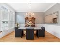 Elegant dining room with a crystal chandelier, decorative wallpaper, and natural light at 77 Ruffed Grouse, Chapel Hill, NC 27517