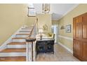 Inviting foyer with wood floors and staircase that leads to the second floor at 821 Ascot Ln, Raleigh, NC 27615