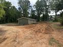 View of the side of the home, deck and the spacious backyard at 8505 Ray Rd, Raleigh, NC 27613