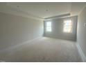 An empty bedroom featuring two large windows and neutral paint at 10 Slippery Elm Rd, Youngsville, NC 27596