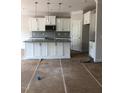 Kitchen featuring white cabinets, granite countertops, gray backsplash and stainless steel appliances at 10 Slippery Elm Rd, Youngsville, NC 27596