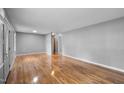 Spacious empty room with gleaming hardwood floors and neutral walls at 110 Starlite Dr, Carrboro, NC 27510