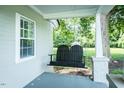 Relaxing porch swing and white columns give this home inviting curb appeal at 1146 W Holt St, Mebane, NC 27302