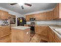 Functional kitchen featuring stainless steel appliances, wood cabinets, a center island, and convenient laundry area at 119 Tadworth Ct, Mebane, NC 27302