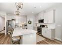 Well-lit modern kitchen featuring white cabinetry, stainless steel appliances, and a spacious island at 1428 Wrenn Rd, Durham, NC 27703