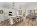 Bright, open-concept kitchen with a large island, modern appliances, and adjacent living area at 1428 Wrenn Rd, Durham, NC 27703