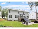 Exterior of home with a fenced backyard, stone patio, metal staircase and a pergola at 2422 Castleburg Dr, Apex, NC 27523