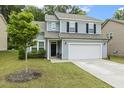 Charming two-story home with a well-manicured lawn and a two-car garage at 267 Dando St, Garner, NC 27529
