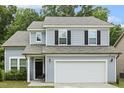 Charming two-story home with a well-manicured lawn and a two-car garage at 267 Dando St, Garner, NC 27529