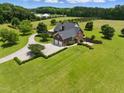 Spacious property with a well-manicured lawn, attached garage, and beautiful landscaping surrounding the home at 280 Phillips Rd, Selma, NC 27576