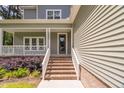 Inviting front entrance with brick steps, white railings, and well-maintained landscaping at 293 Carolina Oaks Ave, Smithfield, NC 27577