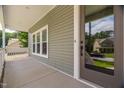 Cozy front porch with neutral siding, white trim, and a view of the neighborhood at 293 Carolina Oaks Ave, Smithfield, NC 27577
