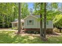 Charming single-Gathering home with green shutters surrounded by mature trees and landscaping at 3007 Appling Way, Durham, NC 27703