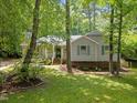 Charming single-Gathering home with green shutters surrounded by mature trees and landscaping at 3007 Appling Way, Durham, NC 27703