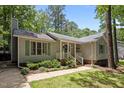 Charming single-Gathering home with green shutters surrounded by mature trees and landscaping at 3007 Appling Way, Durham, NC 27703