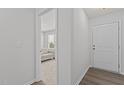 Bright hallway with neutral walls, white trim, and hardwood floors, leading to a cozy living space at 319 Great Northern Station Sta, Apex, NC 27502