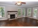 Spacious living room boasts hardwood floors, a fireplace, multiple windows and lots of natural light at 3209 Leebrook Rd, Raleigh, NC 27616