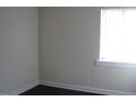 Bright bedroom featuring a window with wooden trim and dark floors at 3514 S Alston Ave, Durham, NC 27713