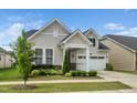 Charming single Gathering home with two-car garage, welcoming porch and manicured landscaping at 512 Courtship Cv, Durham, NC 27703