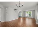 Spacious living room with hardwood floors, chandelier, and staircase at 518 Clearfield Dr, Durham, NC 27703