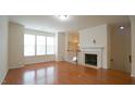 Inviting living area with fireplace, hardwood floors and abundant natural light at 5916 Longeria Ct, Raleigh, NC 27612