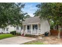 A well-maintained home with a covered front porch, a paved driveway, and neat landscaping at 612 Agin Court Pl, Clayton, NC 27520