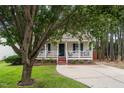 A cozy home featuring a welcoming front porch and a well-maintained lawn at 612 Agin Court Pl, Clayton, NC 27520