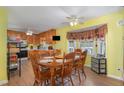 Inviting dining area with a ceiling fan and large wooden table for Gathering meals at 6408 Glen Brack Ct, Raleigh, NC 27603