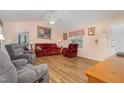 Bright living room with a ceiling fan, artwork, and ample natural light at 6408 Glen Brack Ct, Raleigh, NC 27603