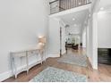 Bright foyer with wood floors, console table, and an open view into the living spaces at 6900 Staghorn Ln, Raleigh, NC 27615