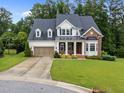 Beautiful two-story home showcasing manicured landscaping, a two-car garage, and a welcoming front lawn at 7502 Latteri Ct, Raleigh, NC 27613
