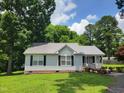 Charming single-story home with a metal roof, black shutters and a welcoming front porch at 78 Phil Johnson Rd, Sanford, NC 27330